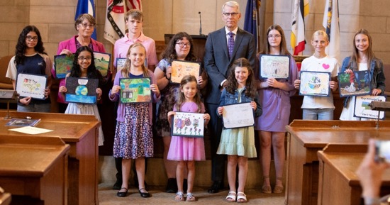 Lt. Gov. Joe Kelly and Nebraska Department of Environment and Energy Deputy Director Kara Valentine honored 13 students whose artwork was chosen to be a part of the 2025 “Nebraska: Don’t Waste It!” Calendar. Pictured are, from left: (front row) Mitra Maruvada, Haezlyn McGowen, Nora Novak, and Lexi Filipi; and (back row) Jeymi Rodriguez, Deputy Director Valentine; Leo Rikli, Emily Hinze, Lt. Gov. Kelly, Hailey Uffelman, Tenley Bruha, and Kiersten Hans. Not pictured are Harley Schmeckpeper, Austin Diebler, and Eh Plae Soe Moo.