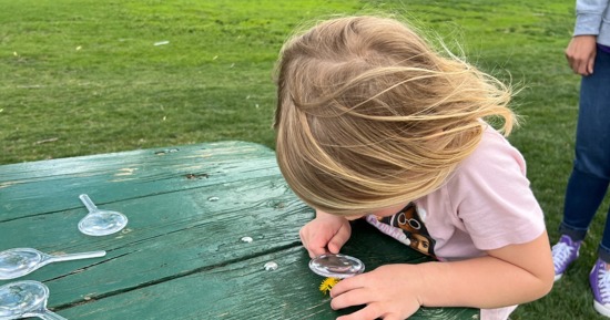 A young girl participates in EPIC's Treasure Hunt at the Pirnie Playground in Grand Island on May