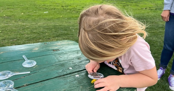 A young girl participates in EPIC's Treasure Hunt at the Pirnie Playground in Grand Island on May