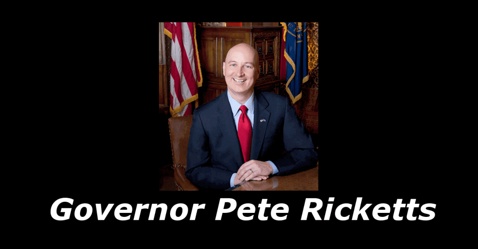 Photo of Pete Rickets sitting in a chair at a table with the United States and Nebraska Flags behind him, The Words Governor Pete Rickets below.